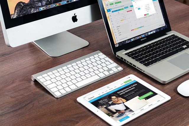 mac desktop, laptop and tablet on a desk