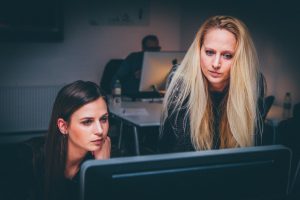 Two women doing template and theme development.